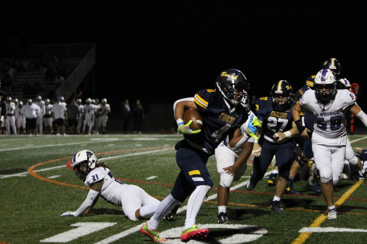 High School North defender in the dust against OB
